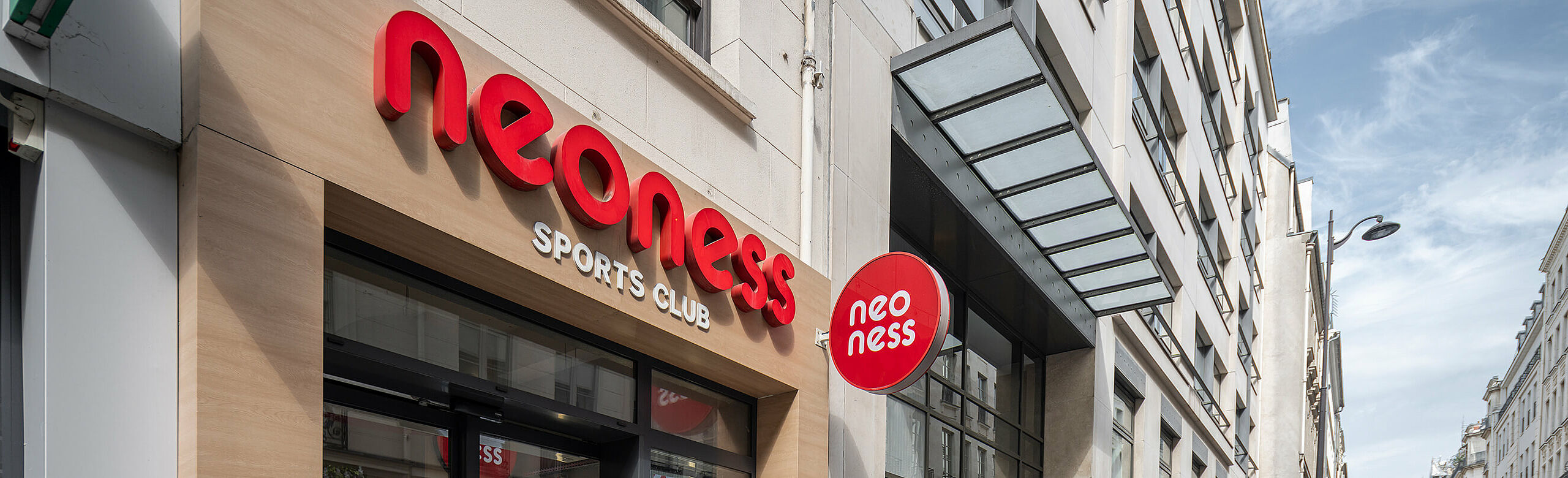 Fitness studio neoness in a mixed-use building in Paris.