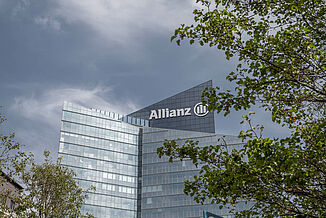 Der Allianz One Tower in Paris mit Bäumen davor.