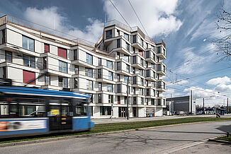 Building complex of the kupa quarter in Munich with passing suburban railway