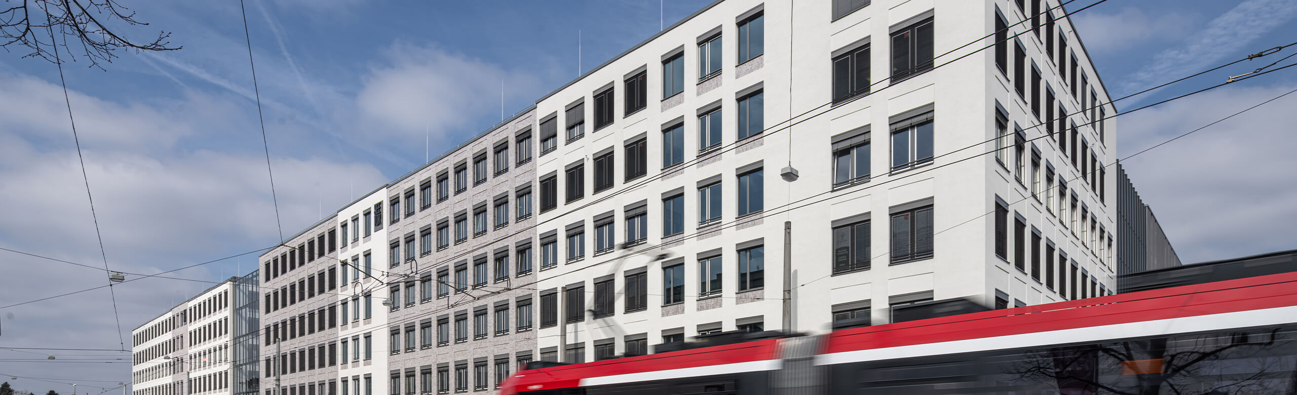 Building complex with passing tram.